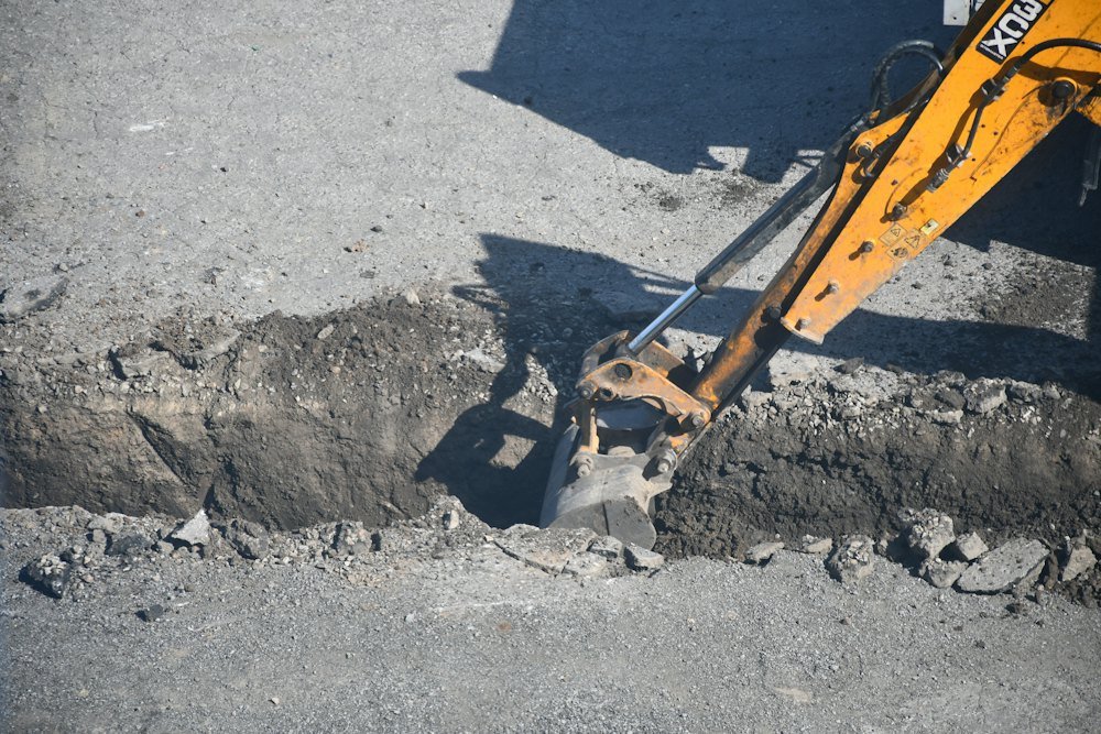 Excavator digging a trench for a sewer line in Bellingham