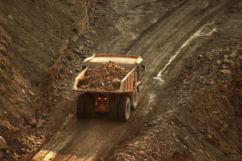 Dump truck hauling material on a dirt road
